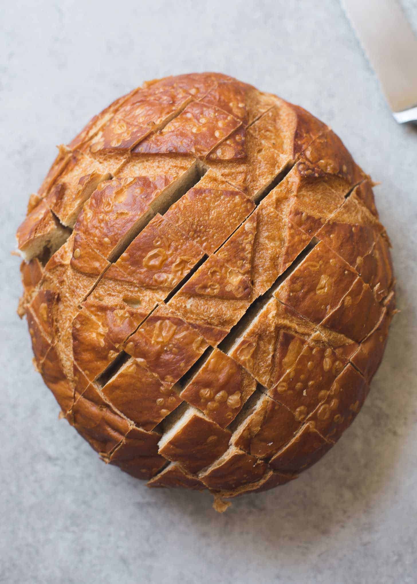 overhead image of a round loaf of bread cut on the top