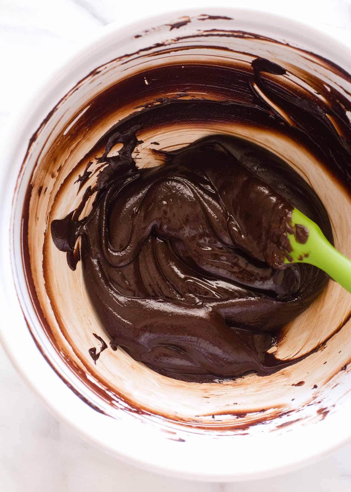 mixing melted chocolate in a clear bowl