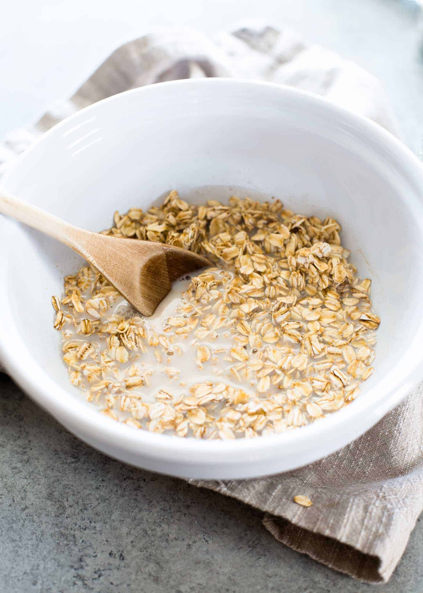 stirring overnight oats in a white bowl