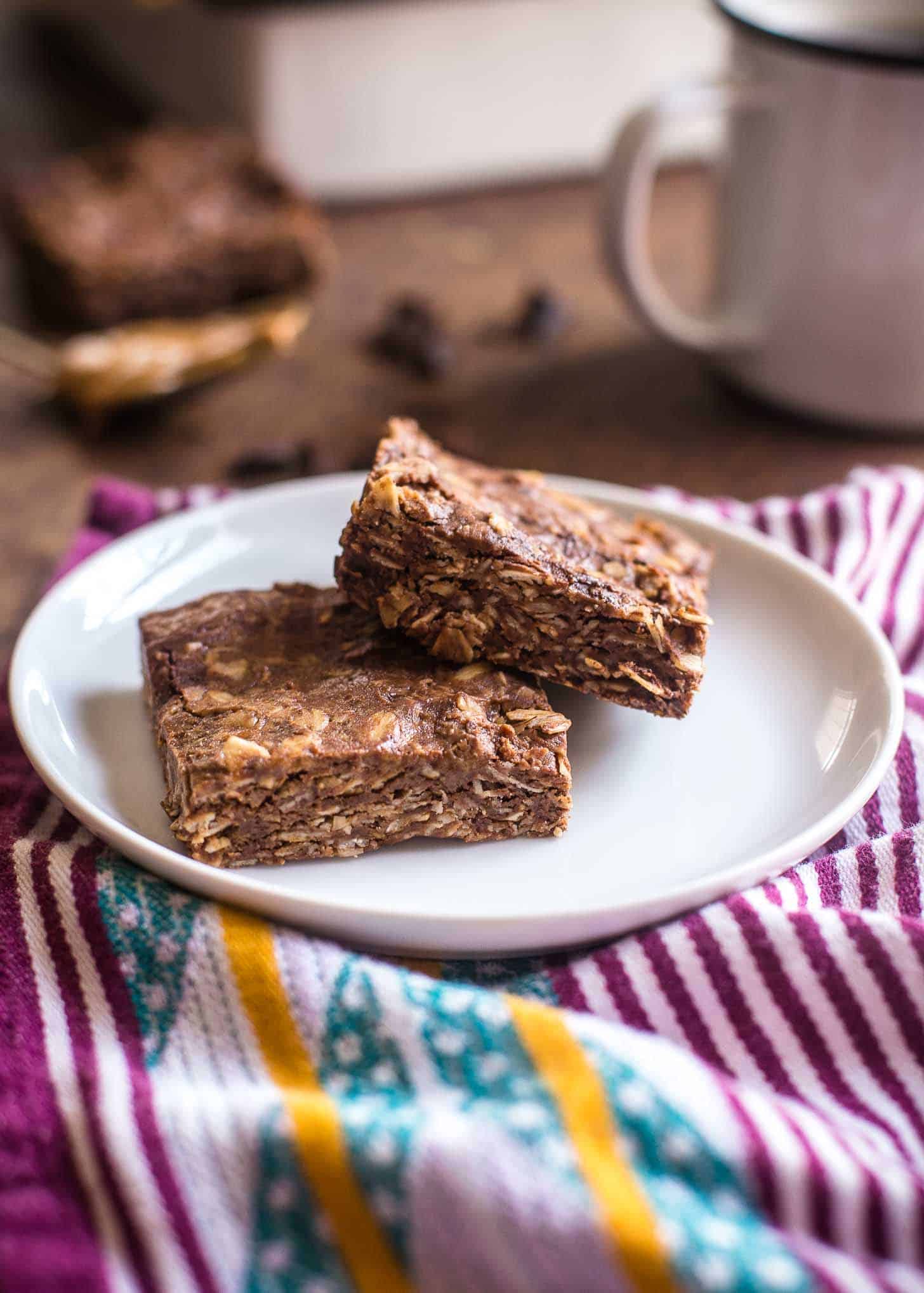 2 Chocolate Peanut Butter Oat Bars on a white plate