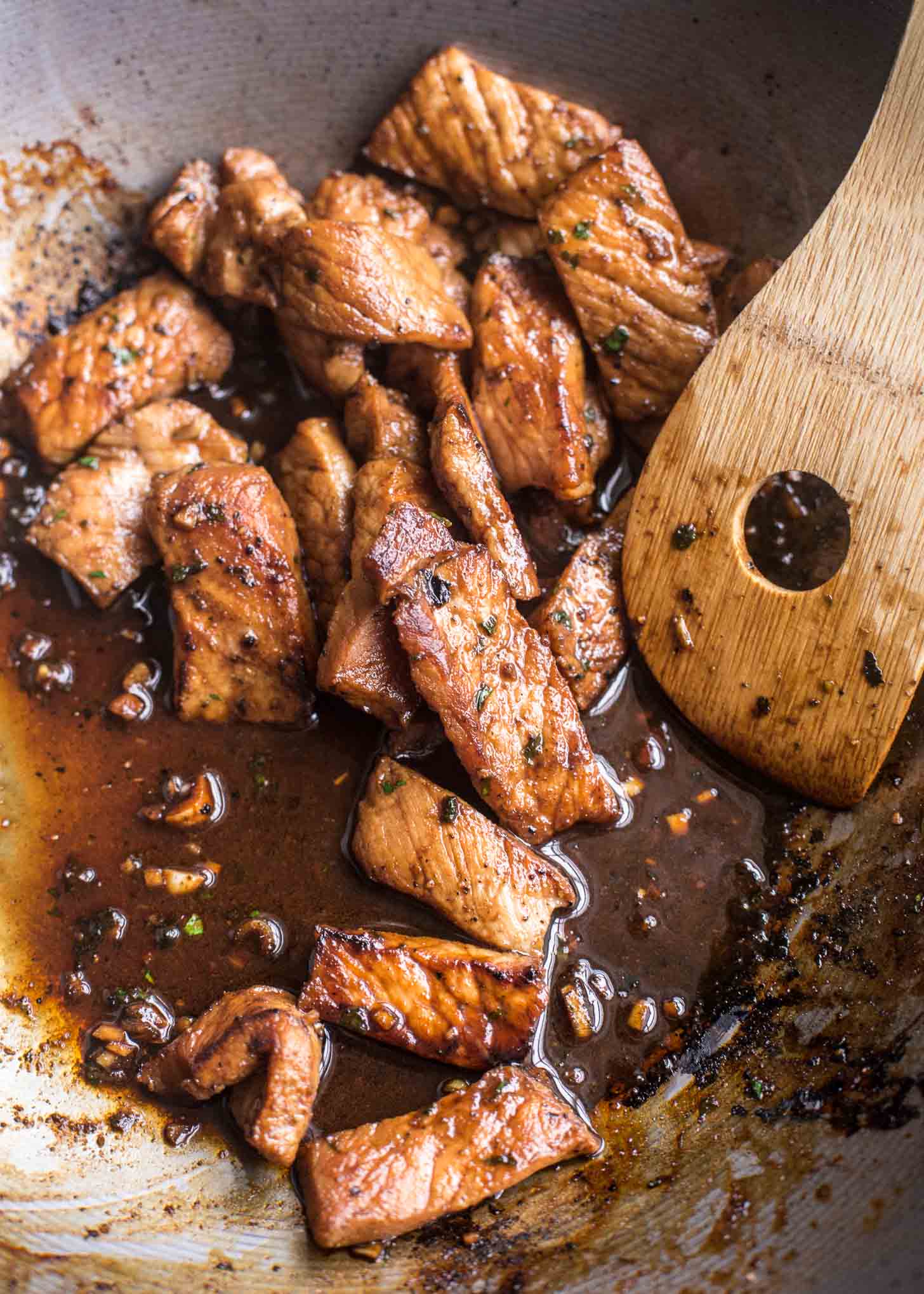 stirring Vietnamese Lemongrass Pork in a wok