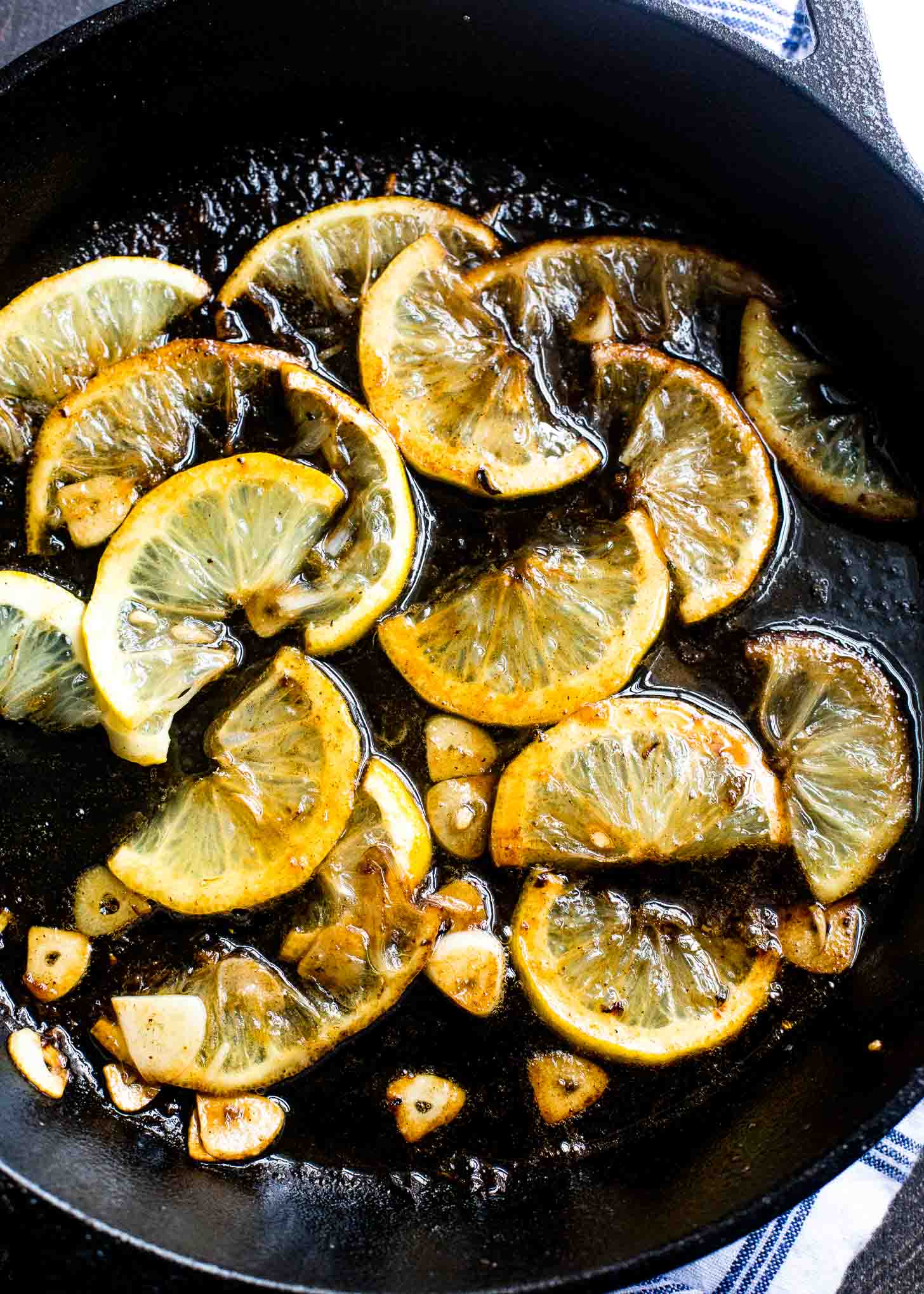 Charred Lemons in a cast iron skillet with sugar and garlic