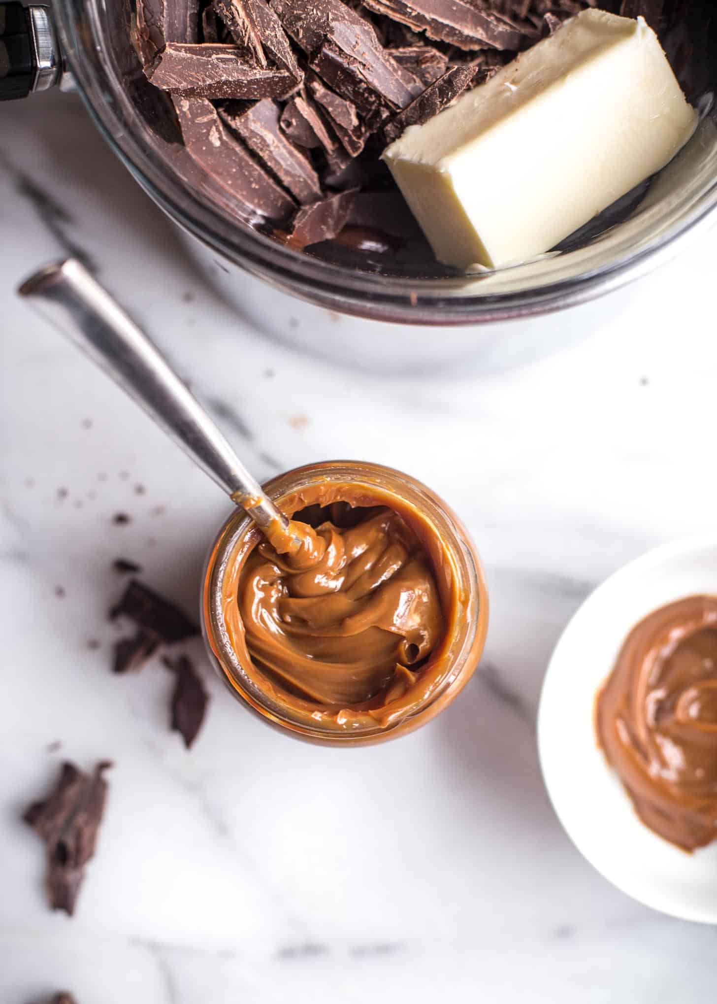 chocolate and butter in a bowl, next to the open jar of dulce de leche
