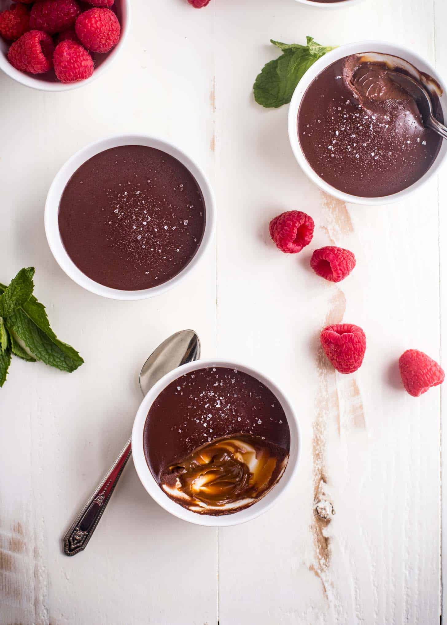 chocolate cream in white ramekins on a white tabletop