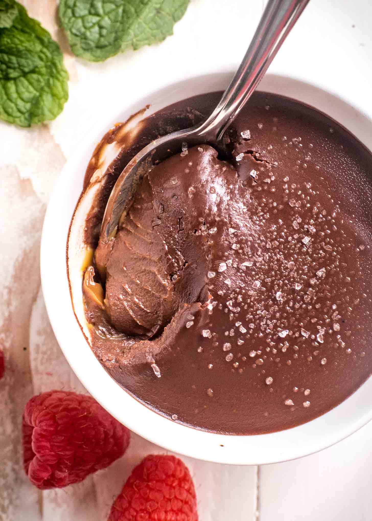 dipping a spoon into a chocolate cream bowl