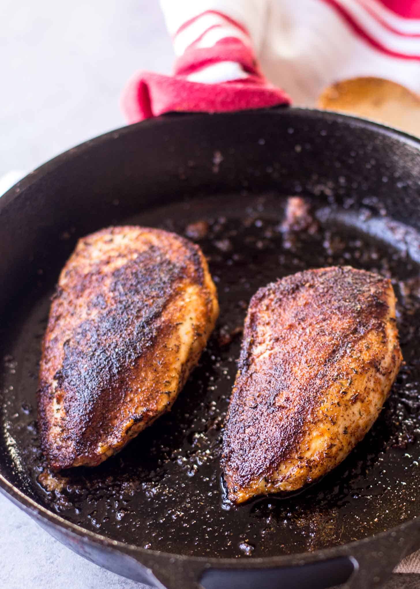cooking chicken in a cast iron skillet