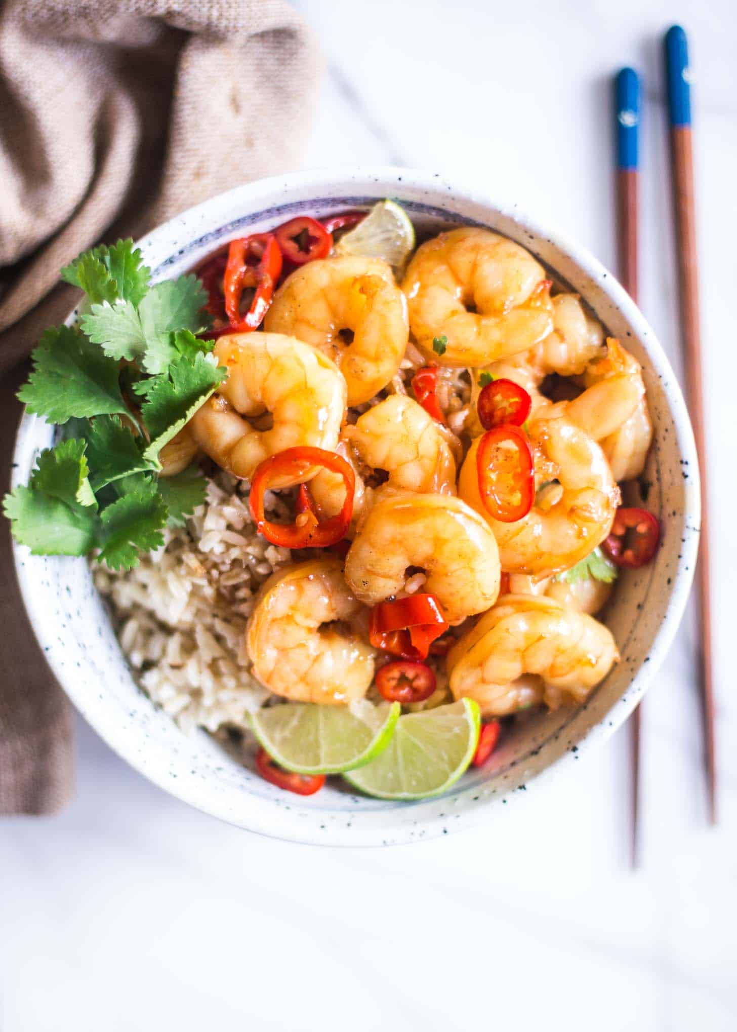shrimp over rice in a white bowl
