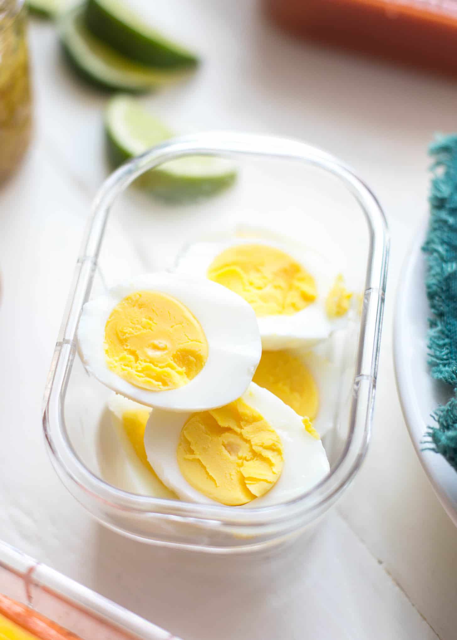 boiled eggs, sliced in half, in a plastic container