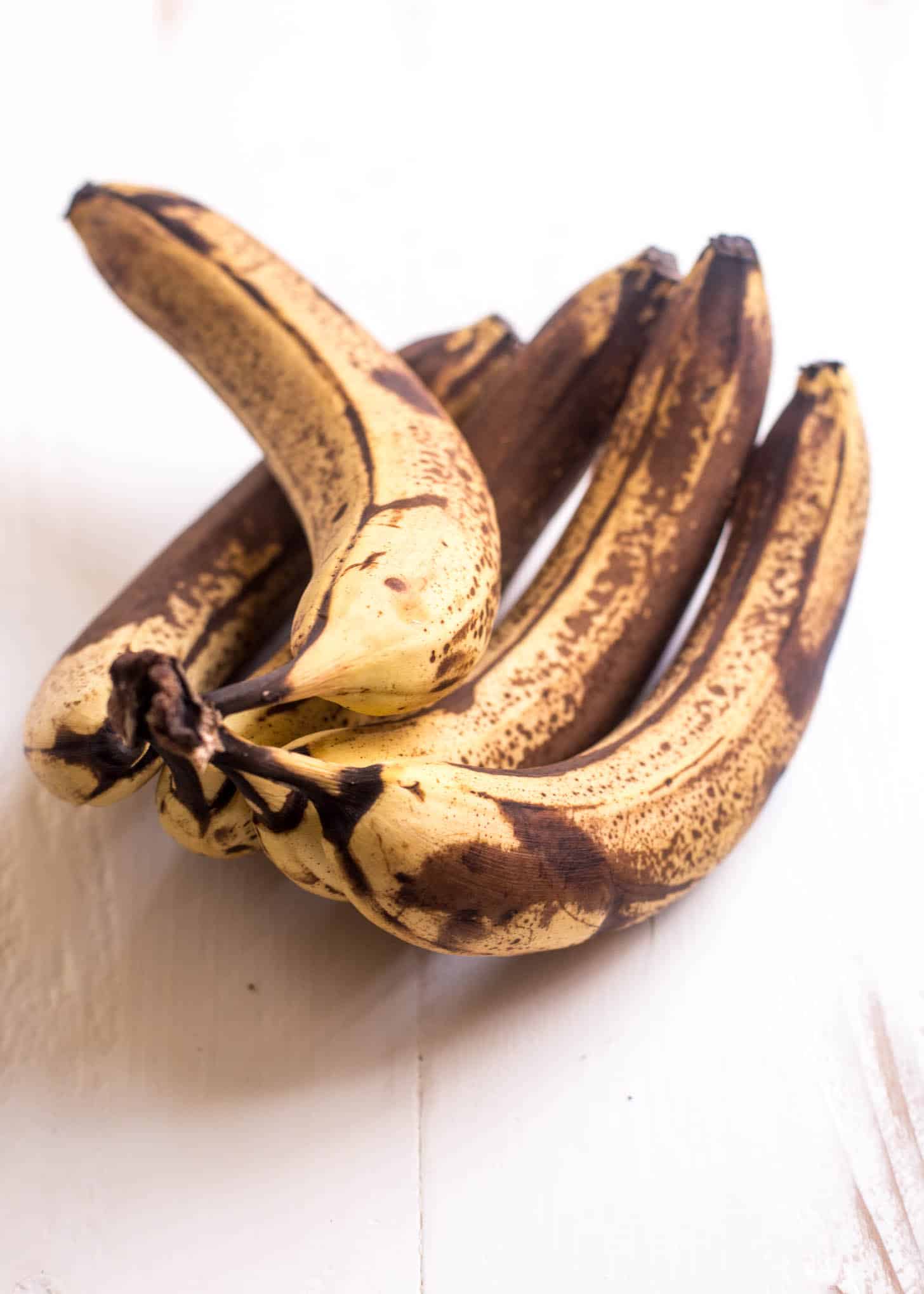 overripe bananas on a white table