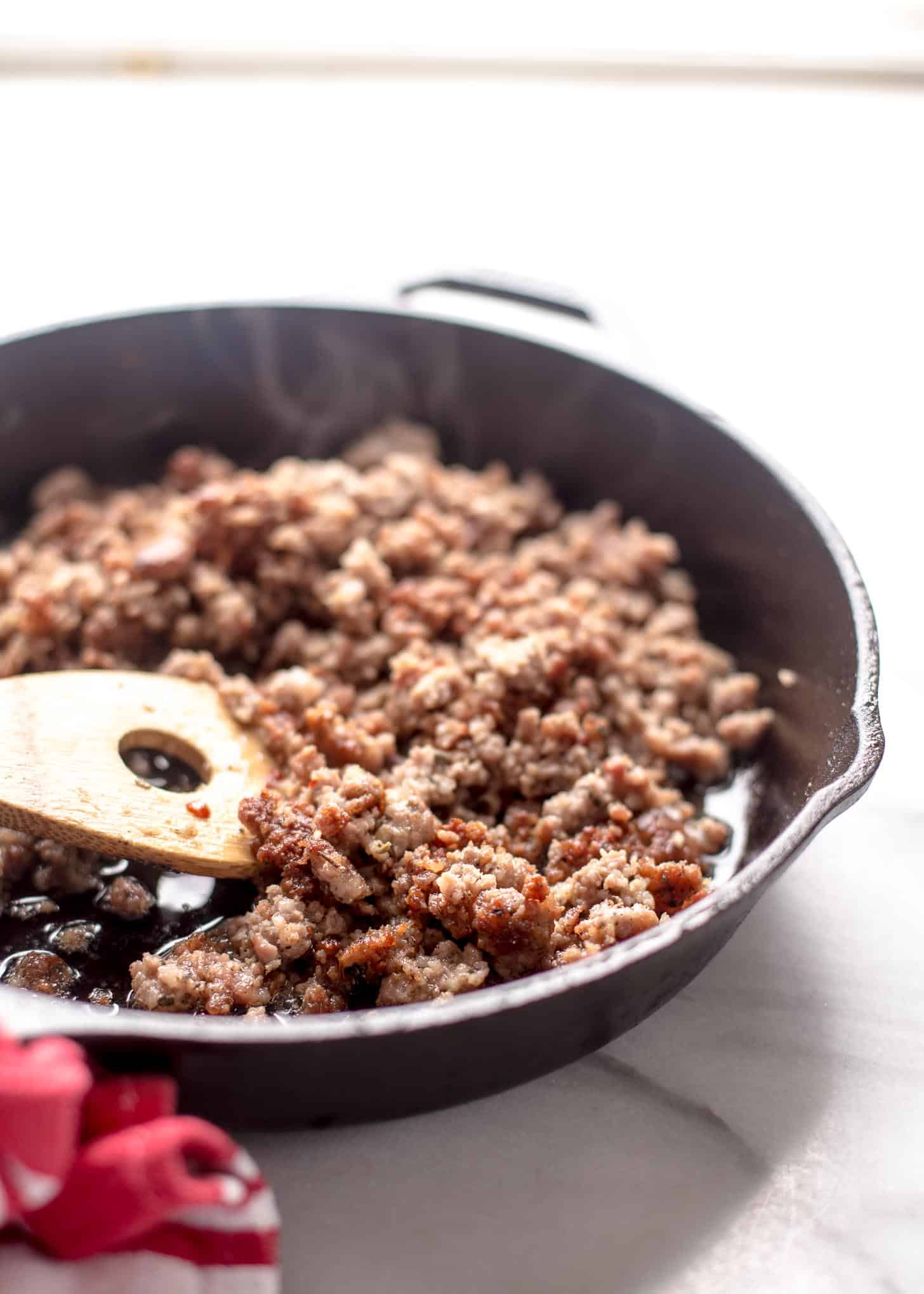 cooking sausage in a cast iron skillet