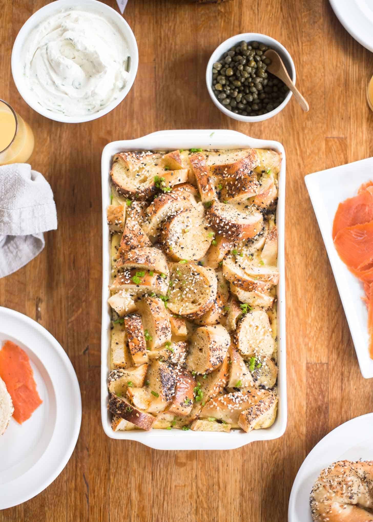 Bagel and Egg casserole in a white baking dish on a table