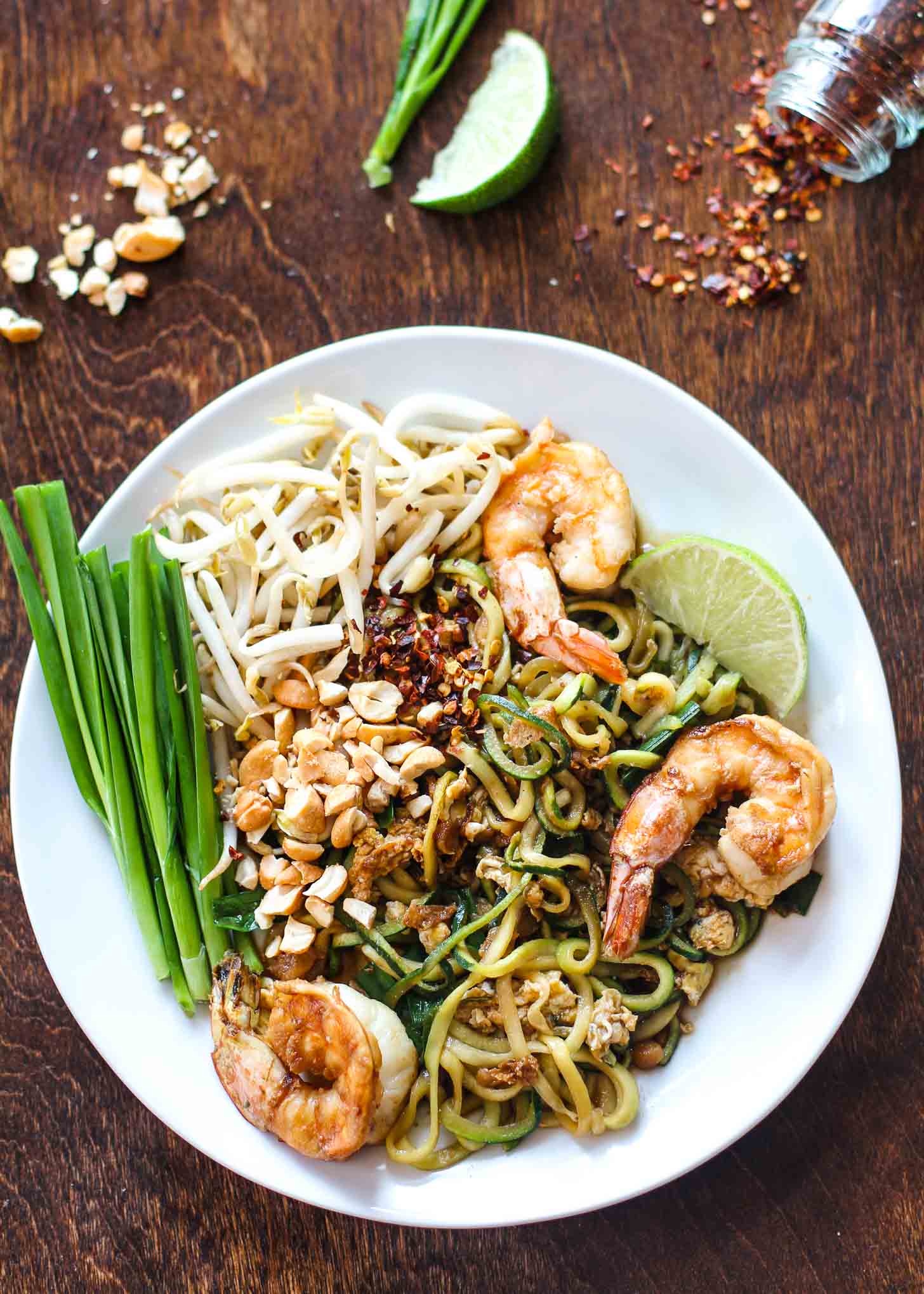 Paleo Pad Thai with Zoodles on a white plate with shrimp