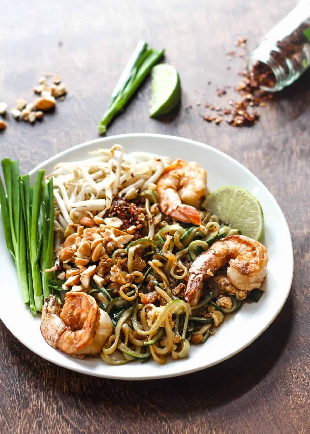 pad thai with zucchini noodles on a white plate