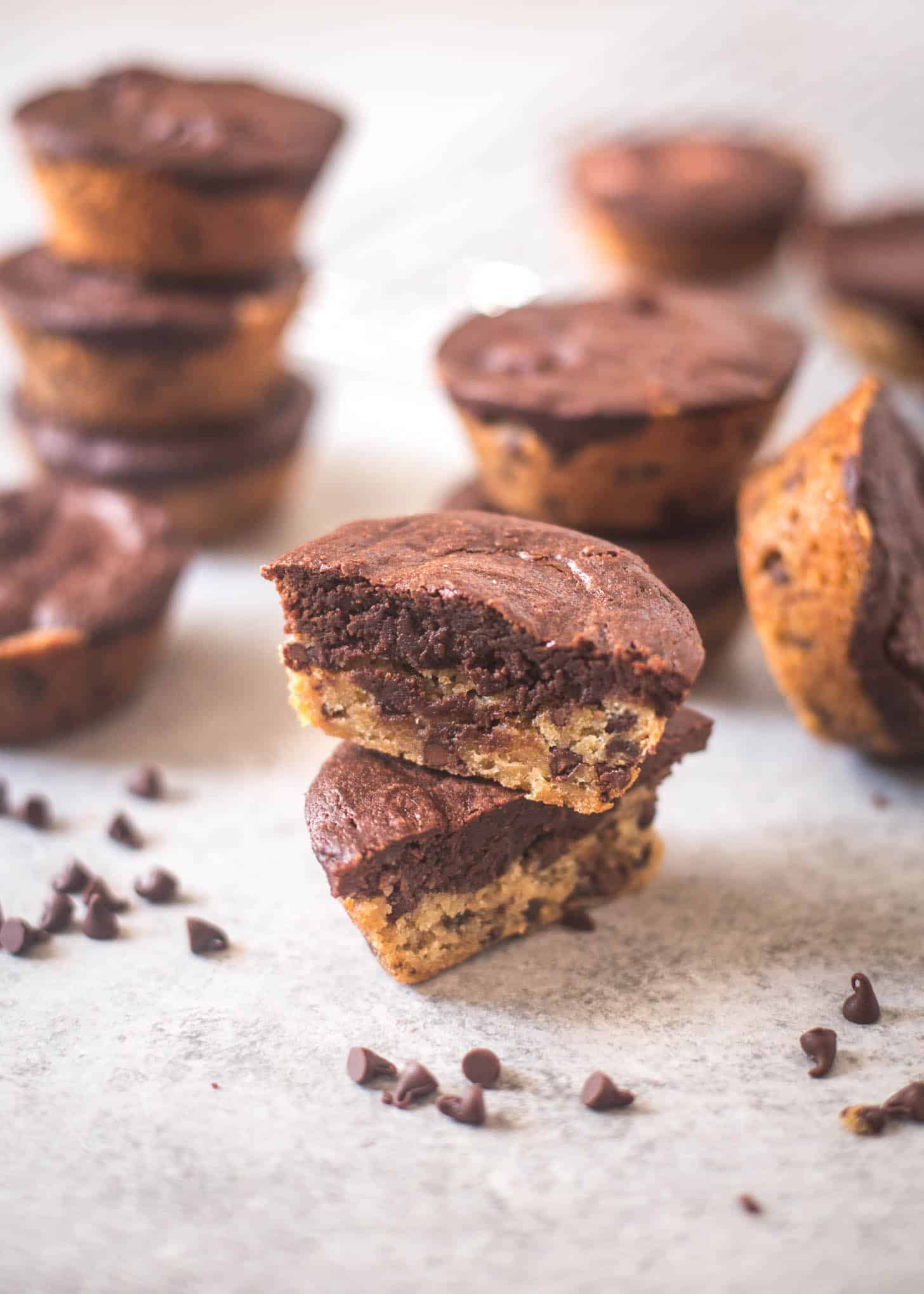 Thick and Chewy Chocolate Chip Cookie Brownies stacked on a white table