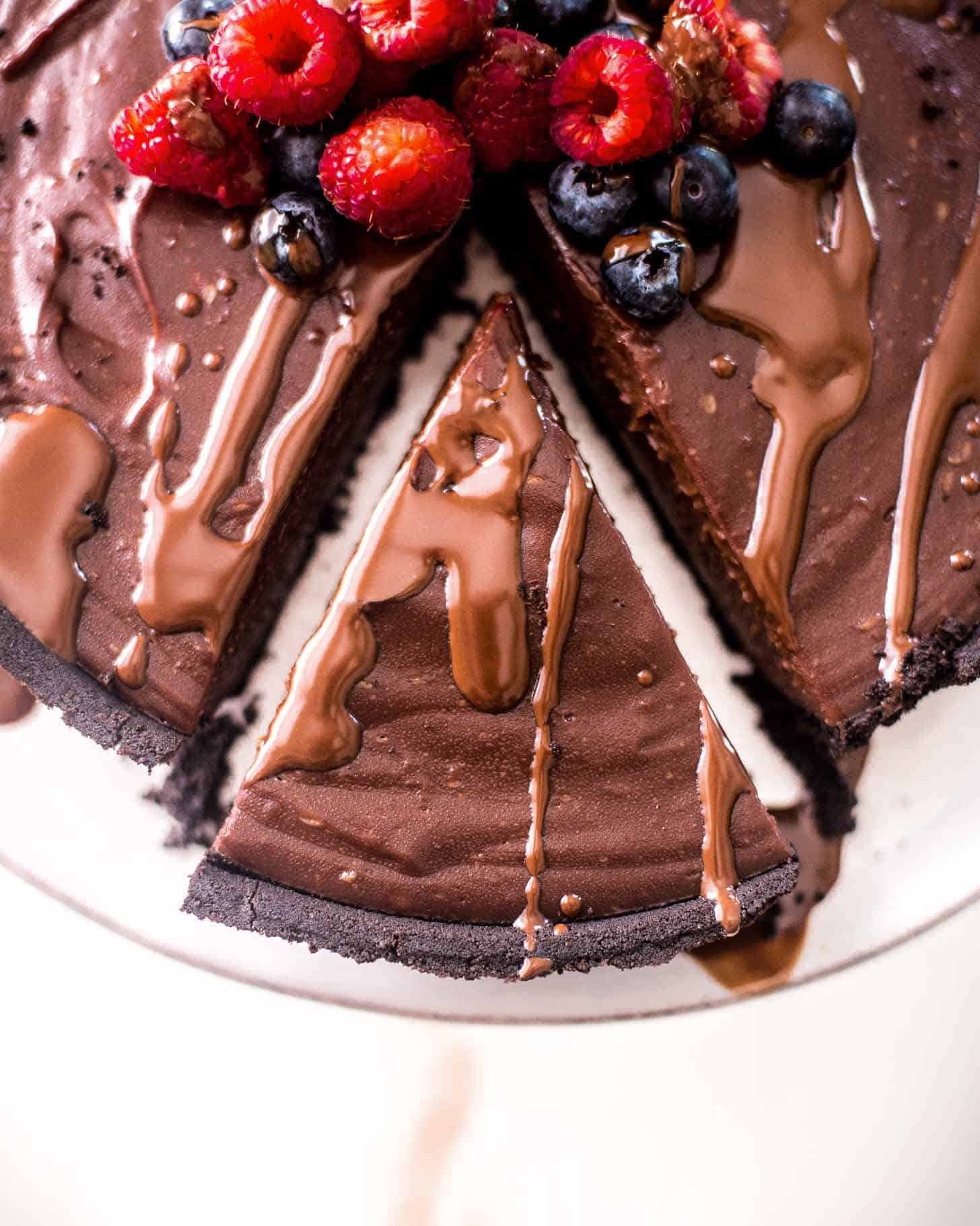 a slice of double chocolate pie topped with berries
