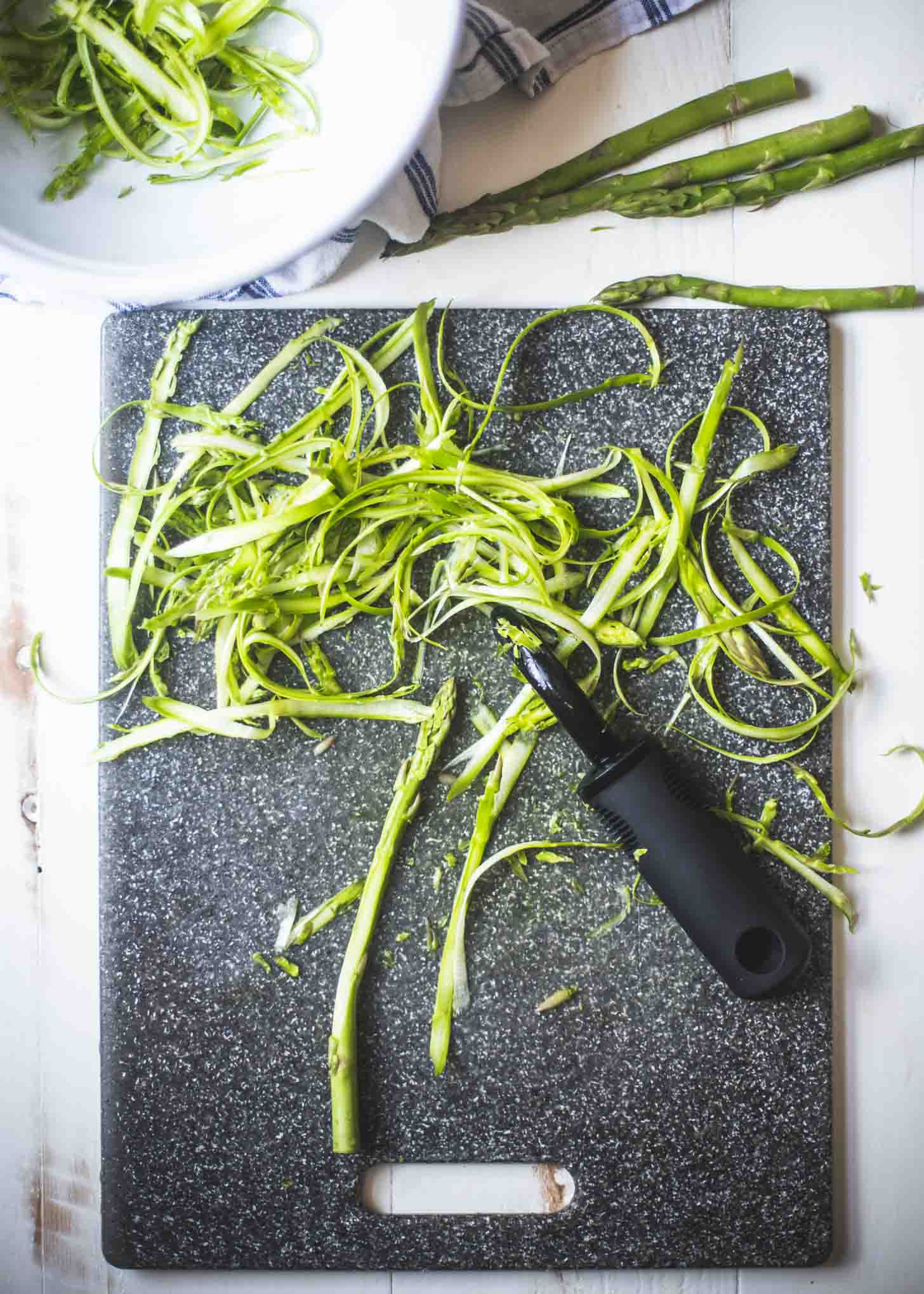 Shaved Asparagus on a cutting board