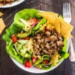 Slow Cooker Carnitas Taco Salad in a white bowl