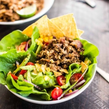 Slow Cooker Carnitas Taco Salad in a white bowl