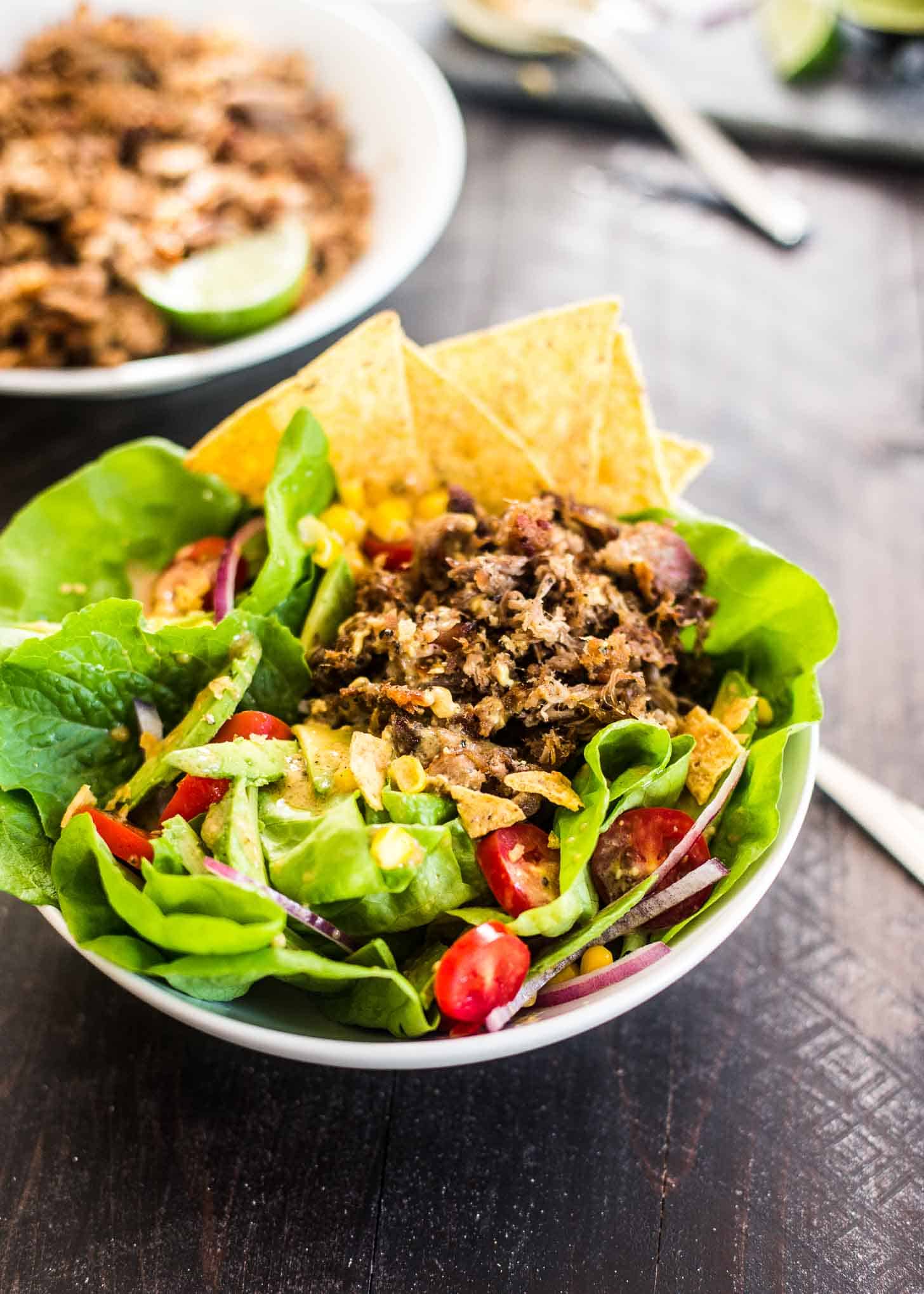 taco Salad in a white bowl with tortilla chips