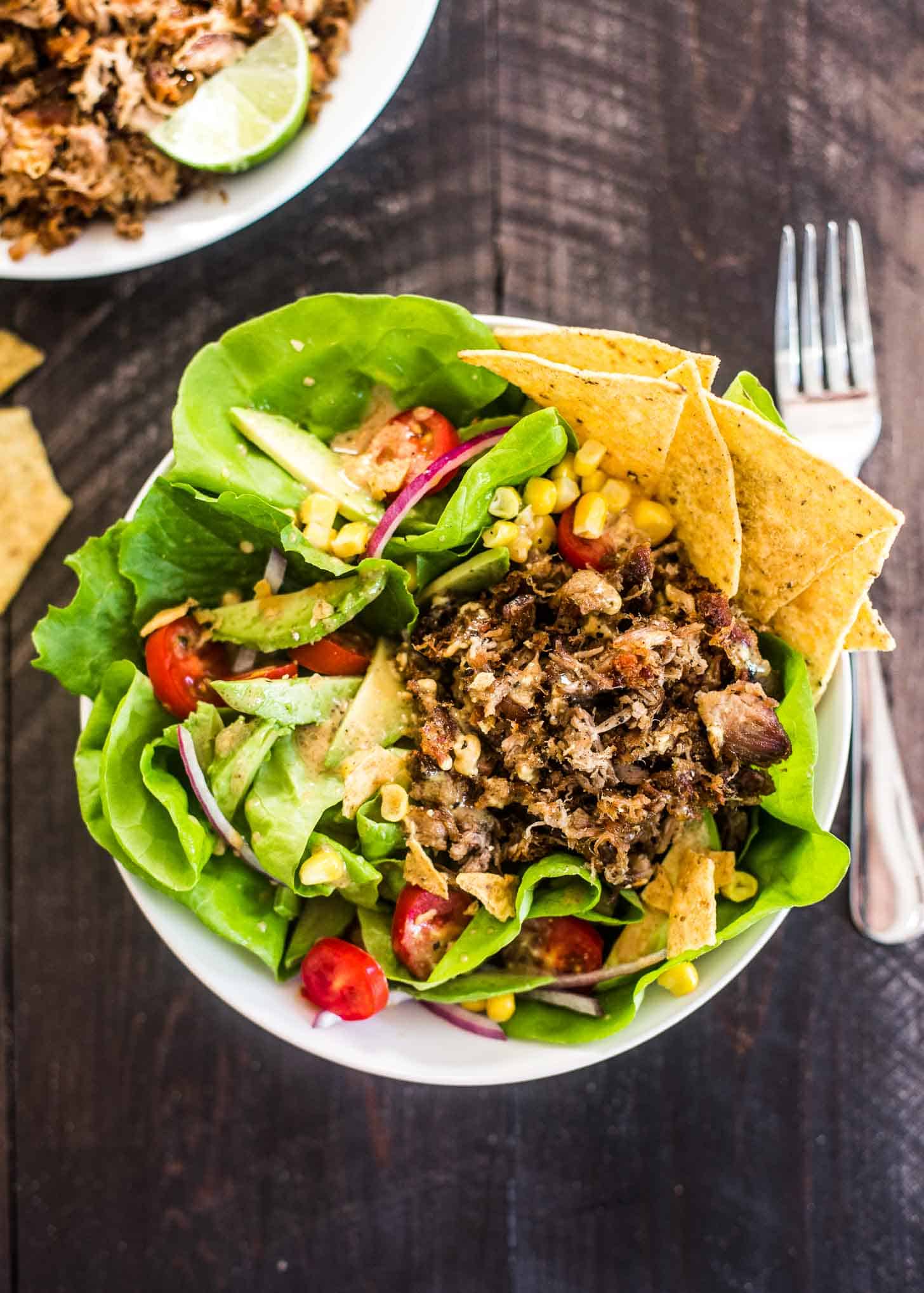 carnitas taco Salad in a white bowl with tortilla chips