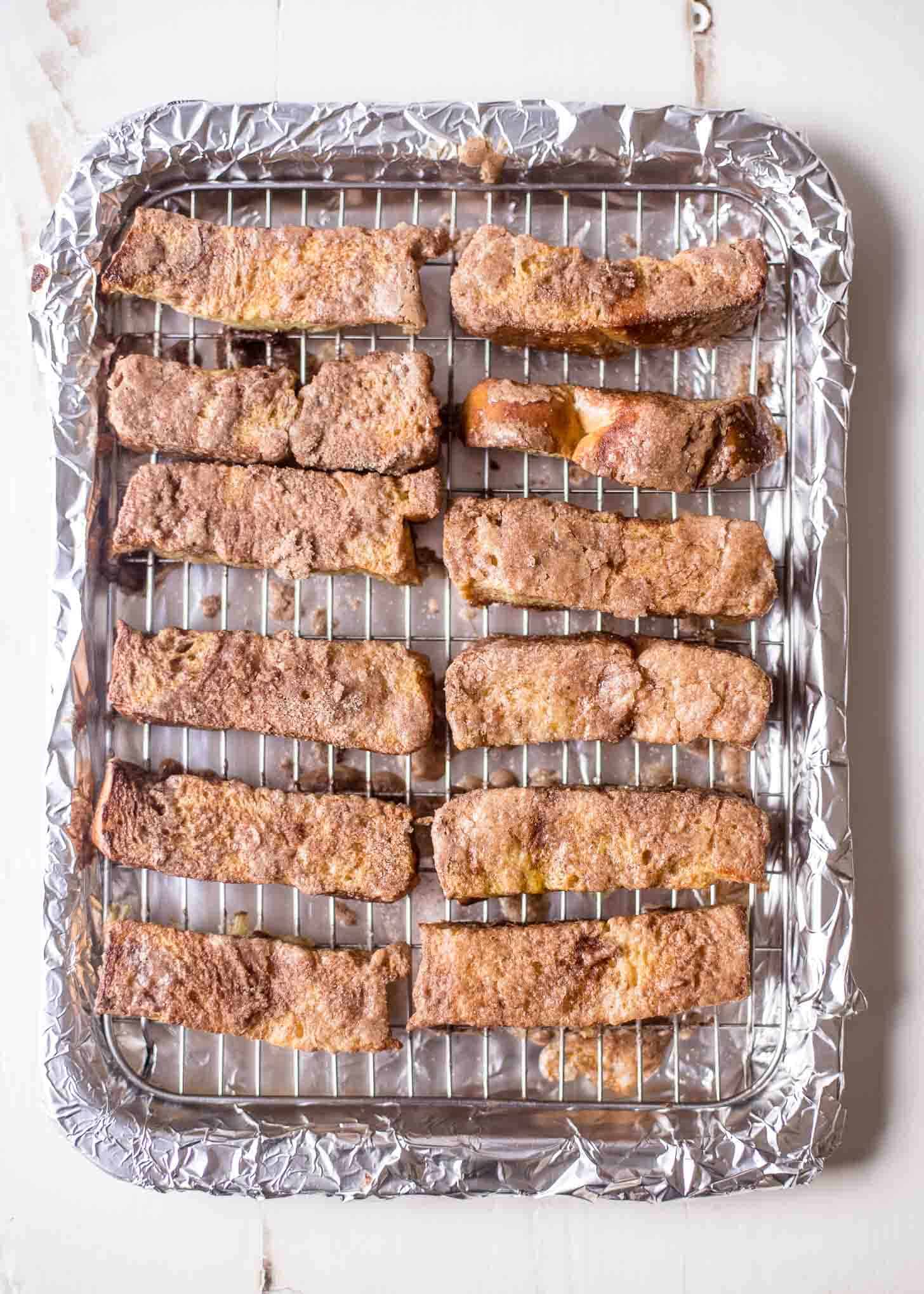 overhead image of cinnamon french toast sticks on a wire rack