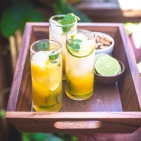 passion fruit mojitos on a tray outside