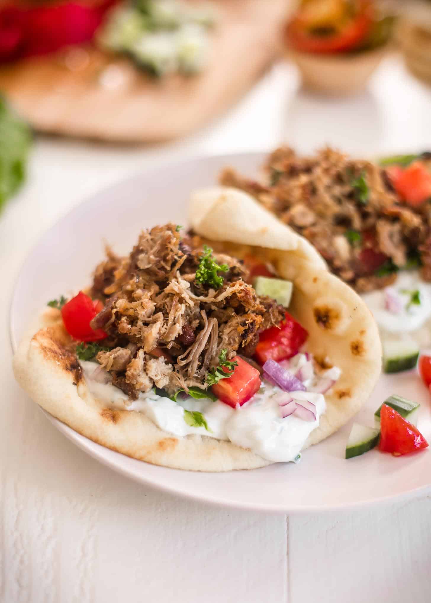 crispy pork in Gyros on a white plate