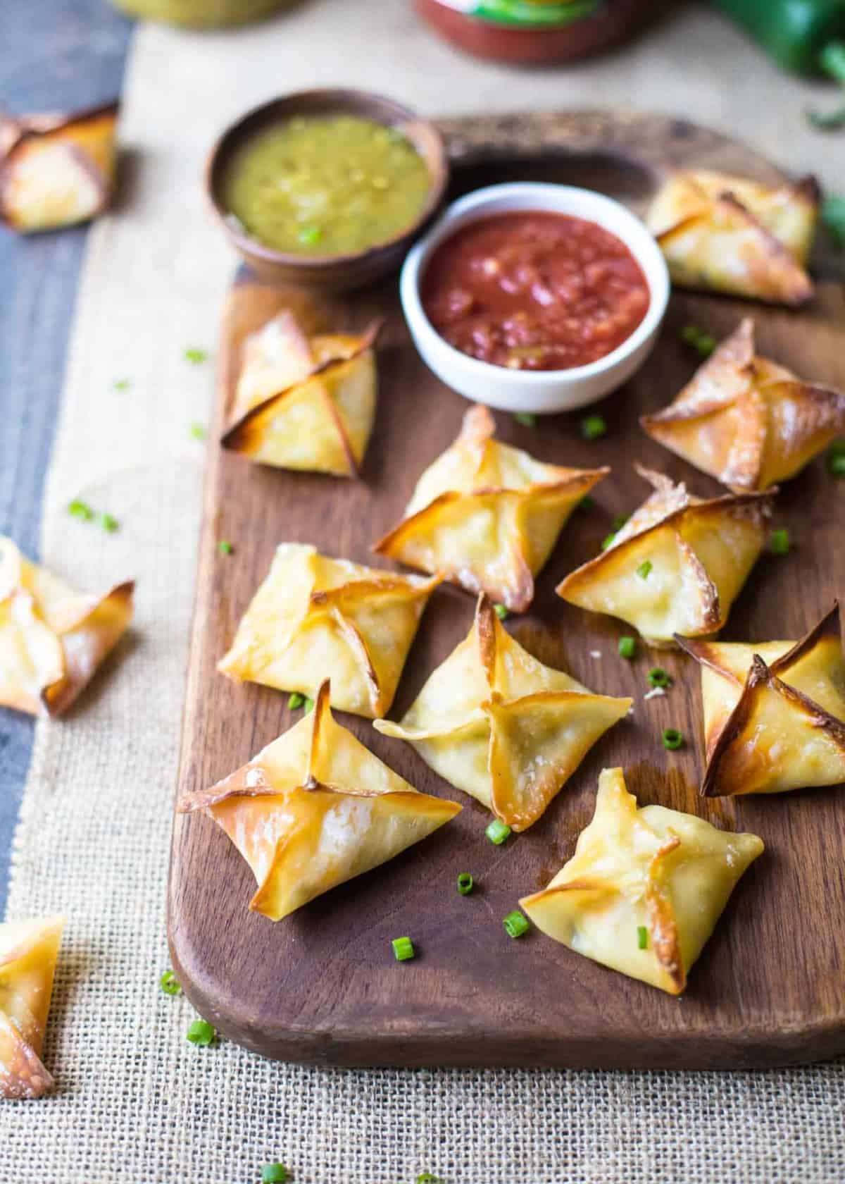 Baked Cheesy Chicken Wontons on a wooden tray