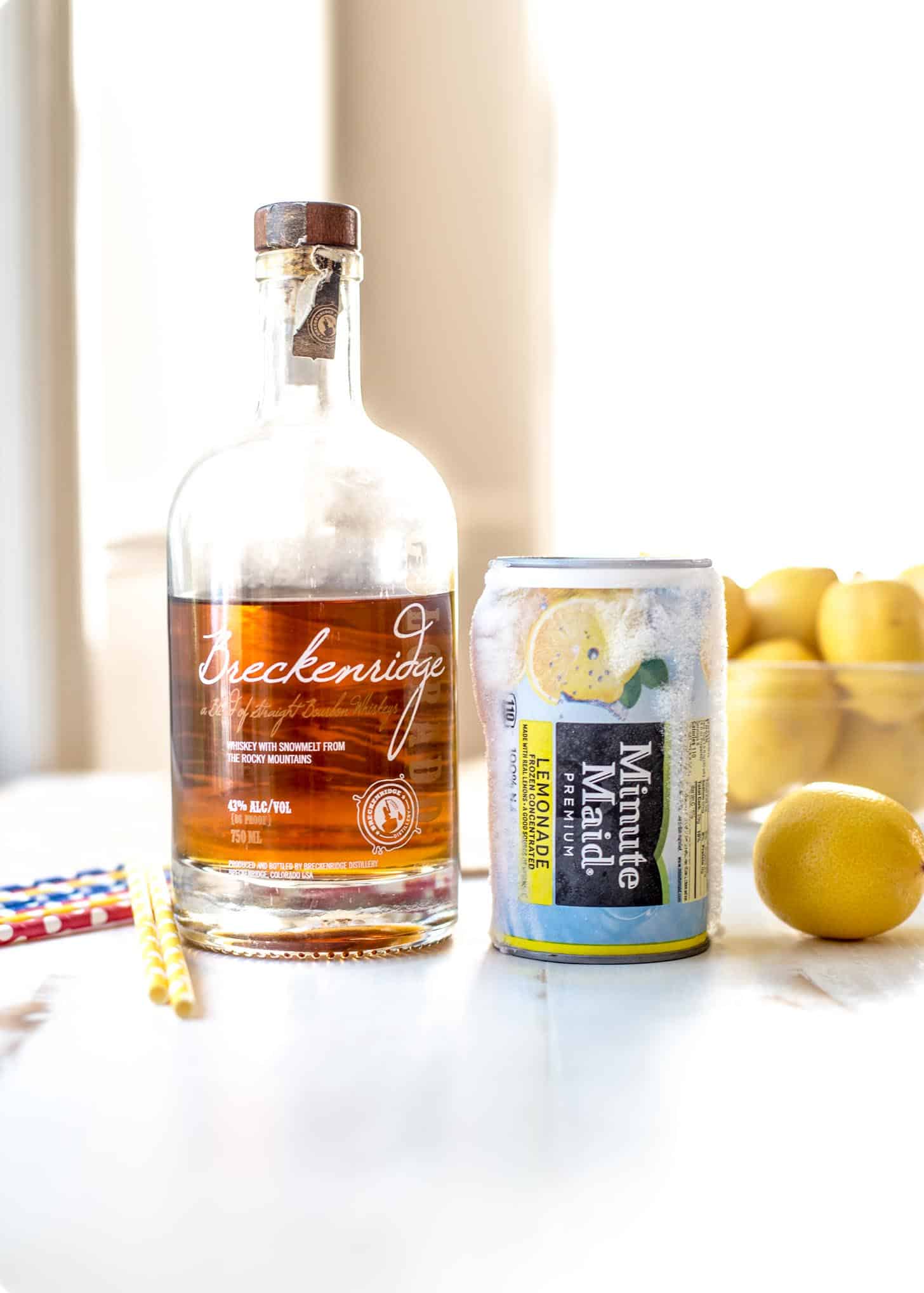 ingredients for bourbon lemonade slush on a white table