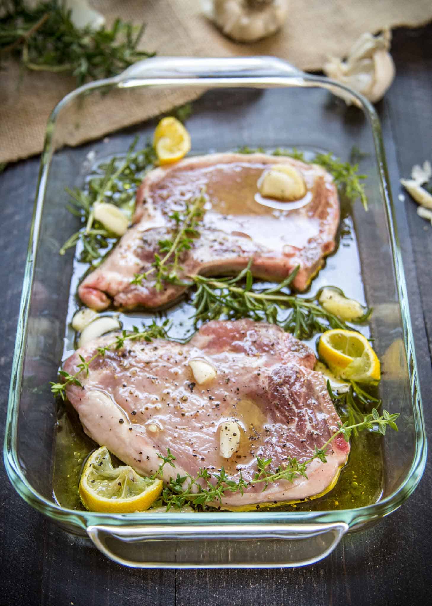 marinating pork chops in herb mixture