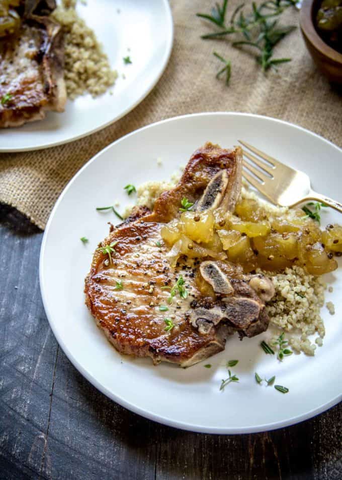 Herb Marinated Pork Chops with Apple Chutney on a white plate