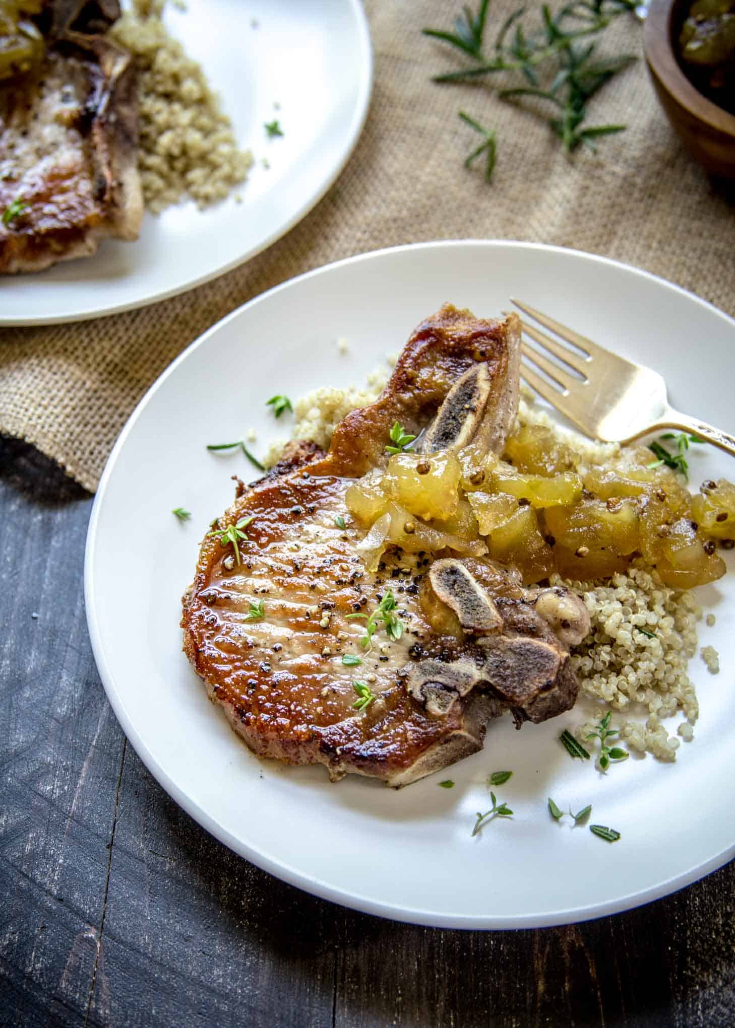 overhead image of Herb Marinated Pork Chops with Apple Chutney on a white plate