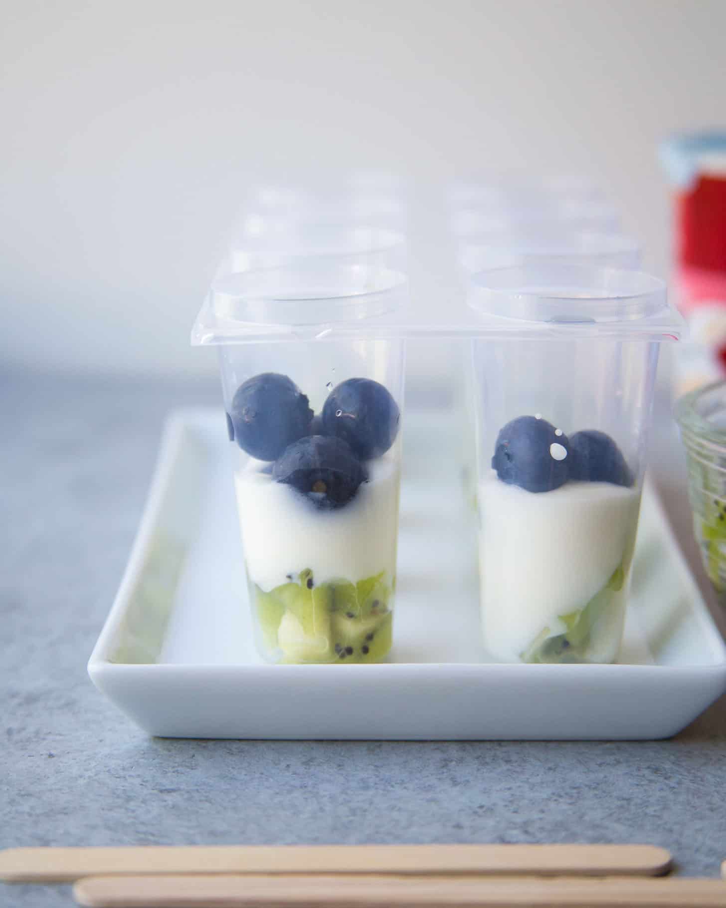 adding fruit to popsicle molds