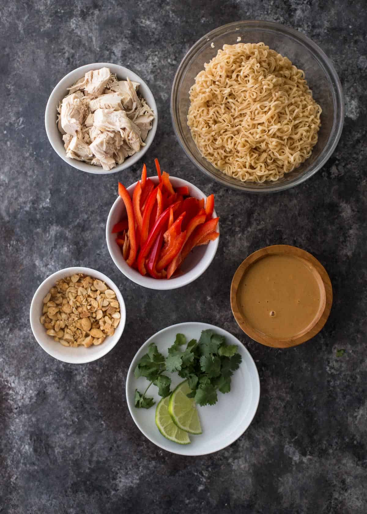 overhead image of ingredients for thai peanut noodles on a grey countertop