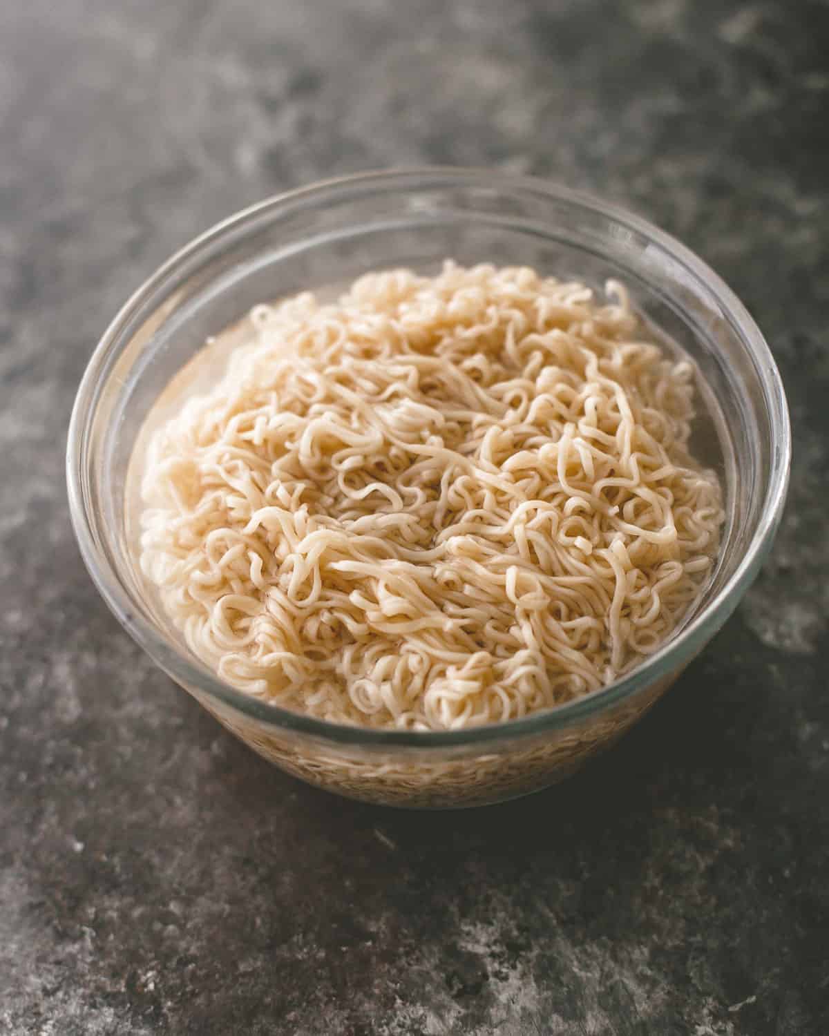 cooked ramen noodles in a clear bowl