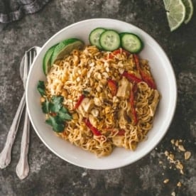 chicken peanut noodles in a white bowl