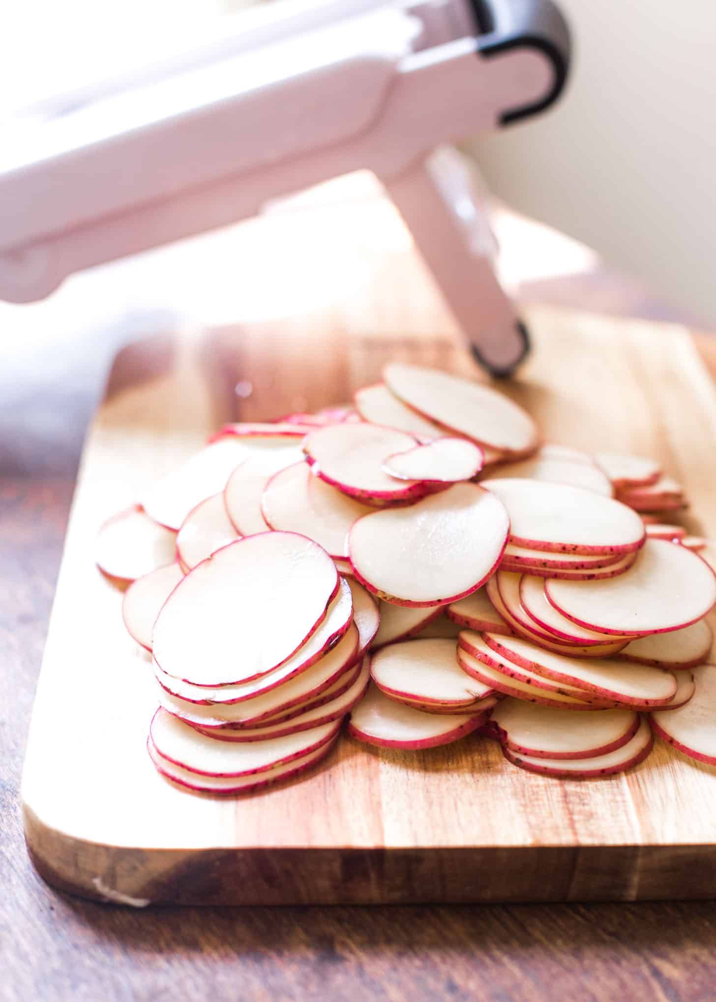 sliced potatoes on a wooden board