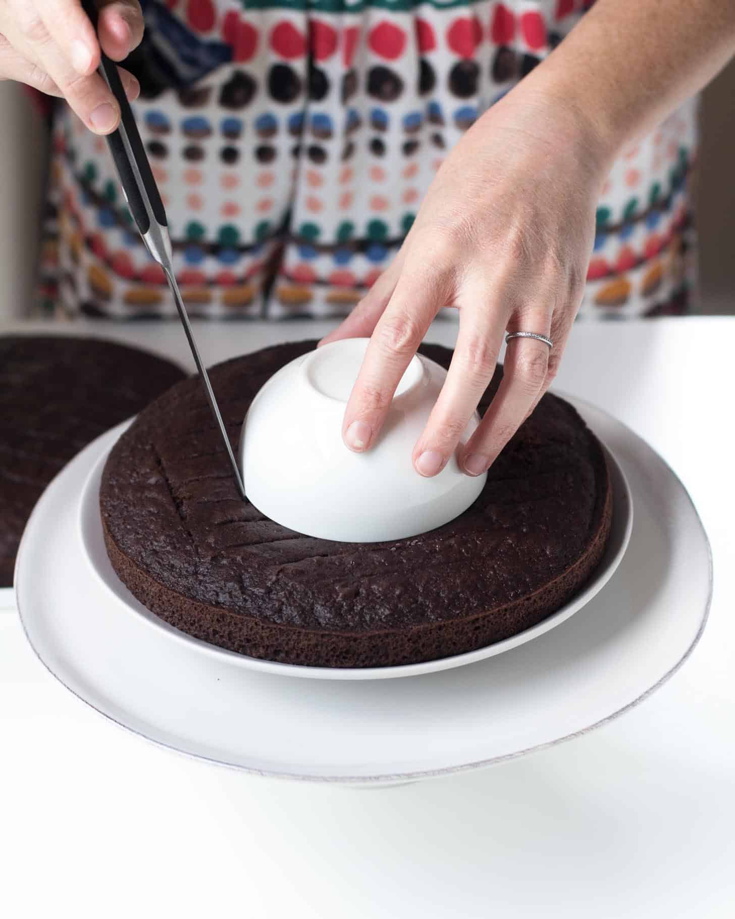 cutting the center out of a chocolate cake