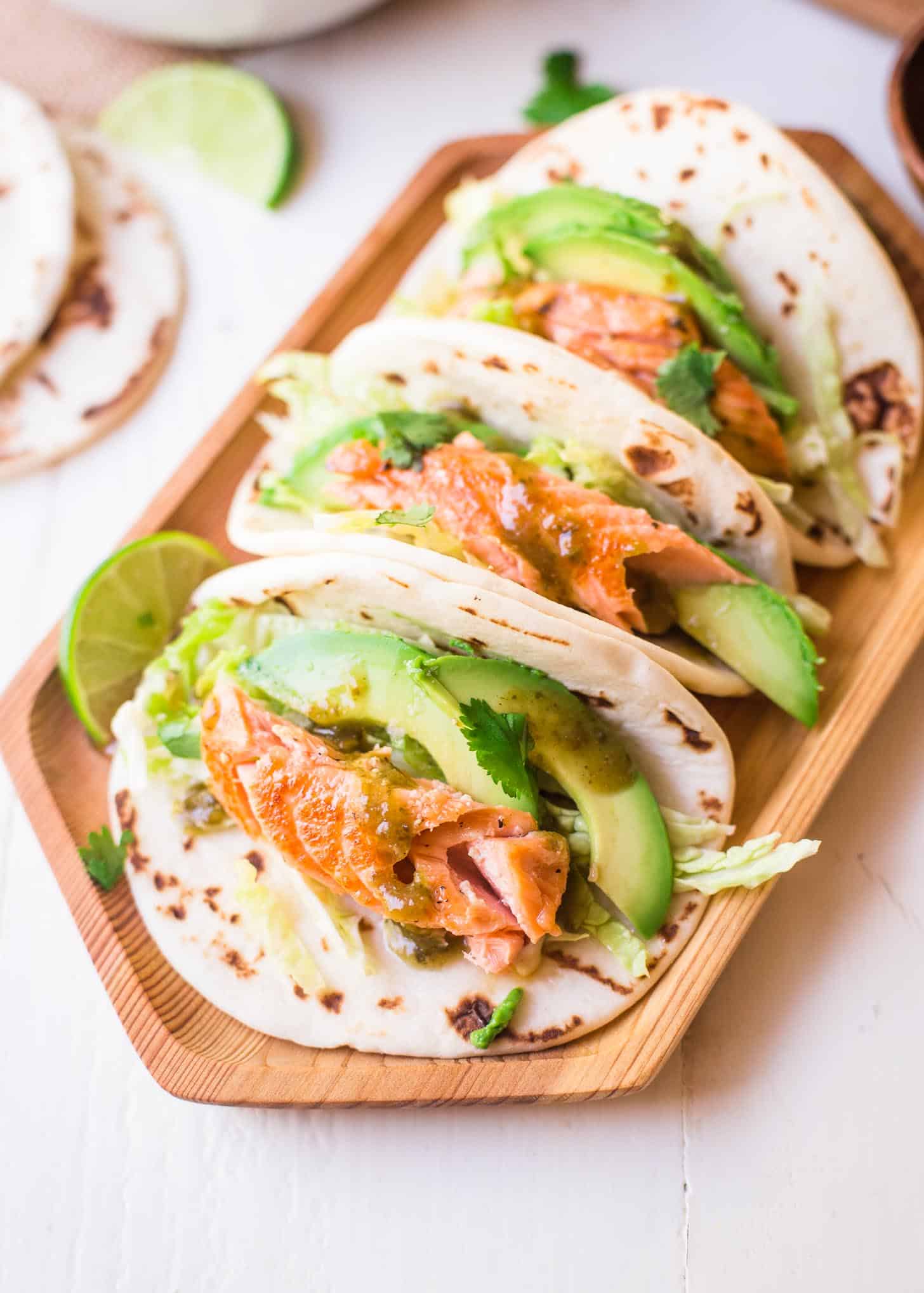 Honey Lime Salmon Tacos on a wooden tray