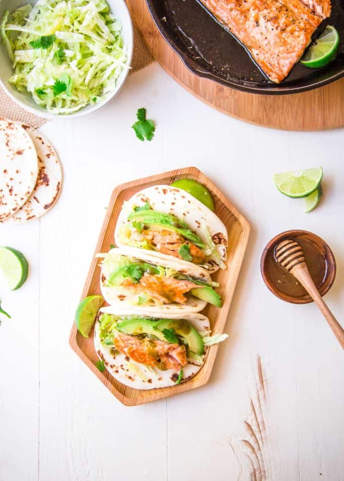 Honey Lime Salmon Tacos on a wooden tray