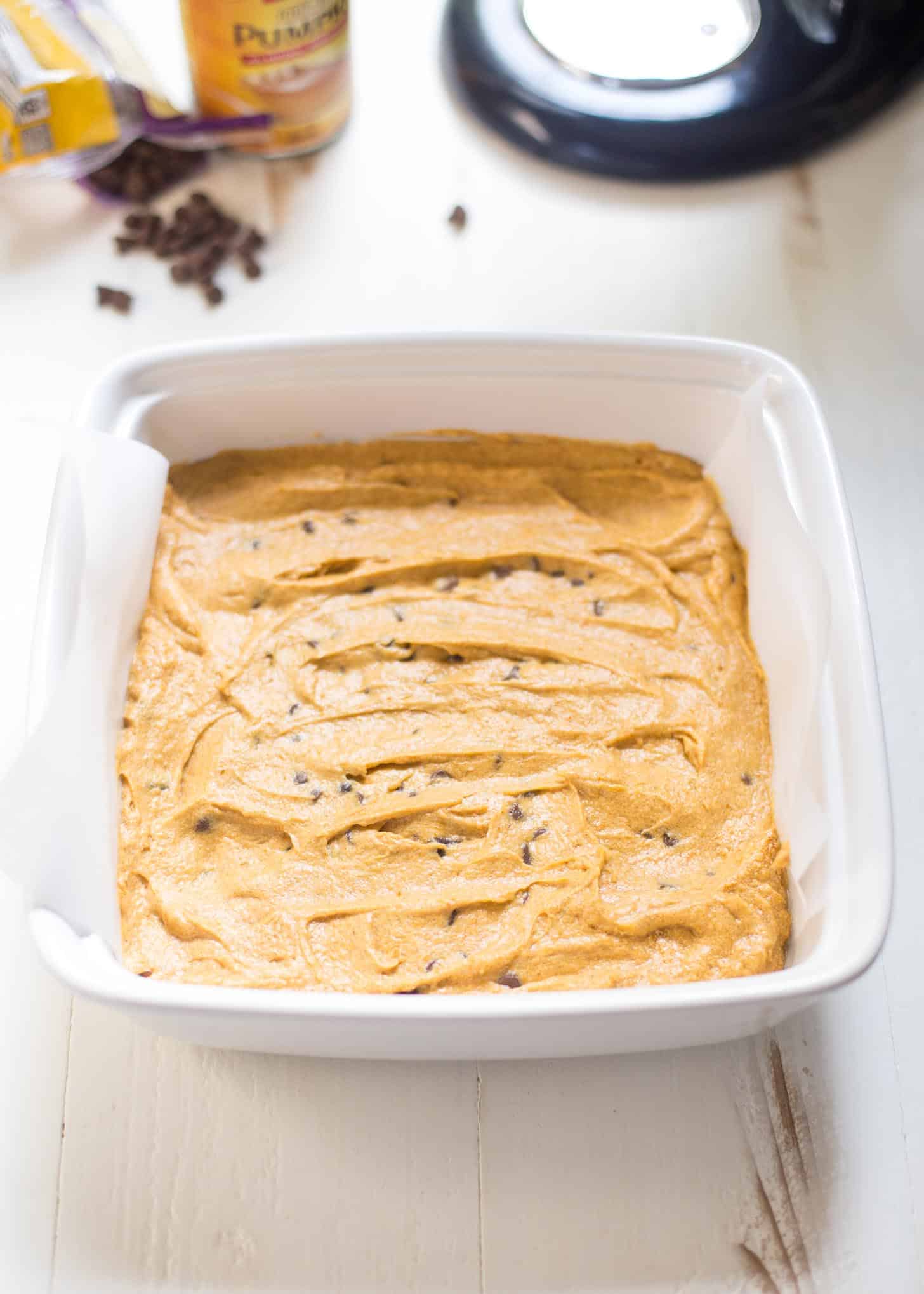 unbaked Pumpkin Chocolate Chip Snack Cake in a white baking dish