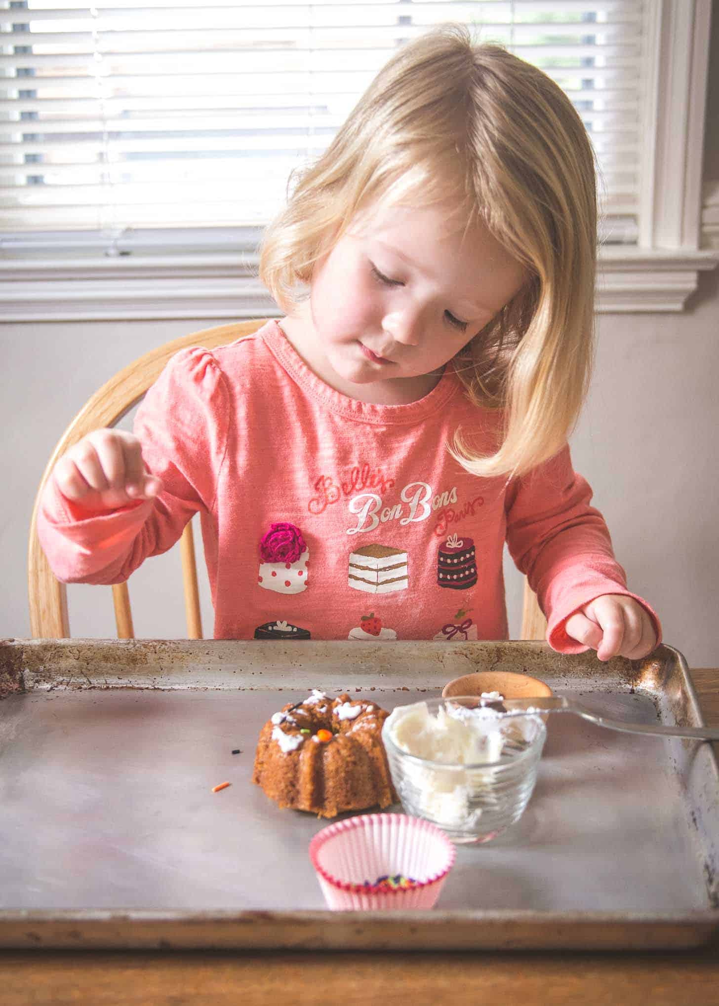 clara adding sprinkles to a mini cake