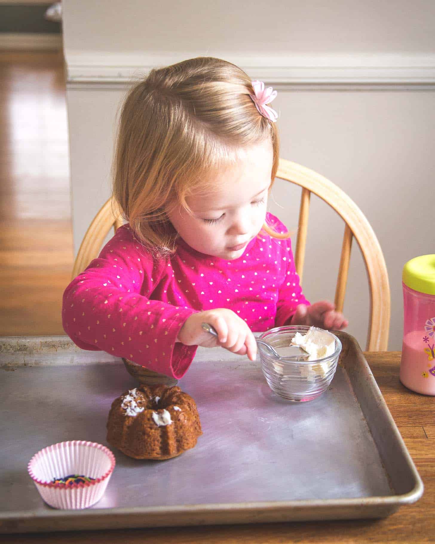 Molly putting icing on a mini cake