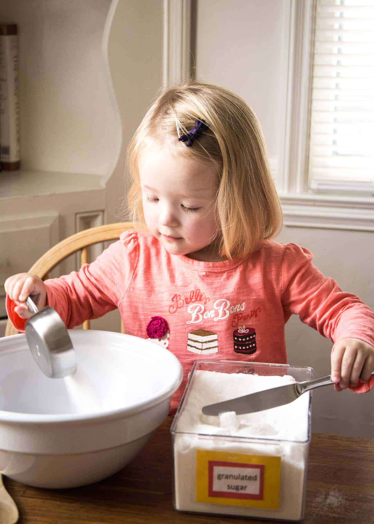 Clara adding flour to a bowl