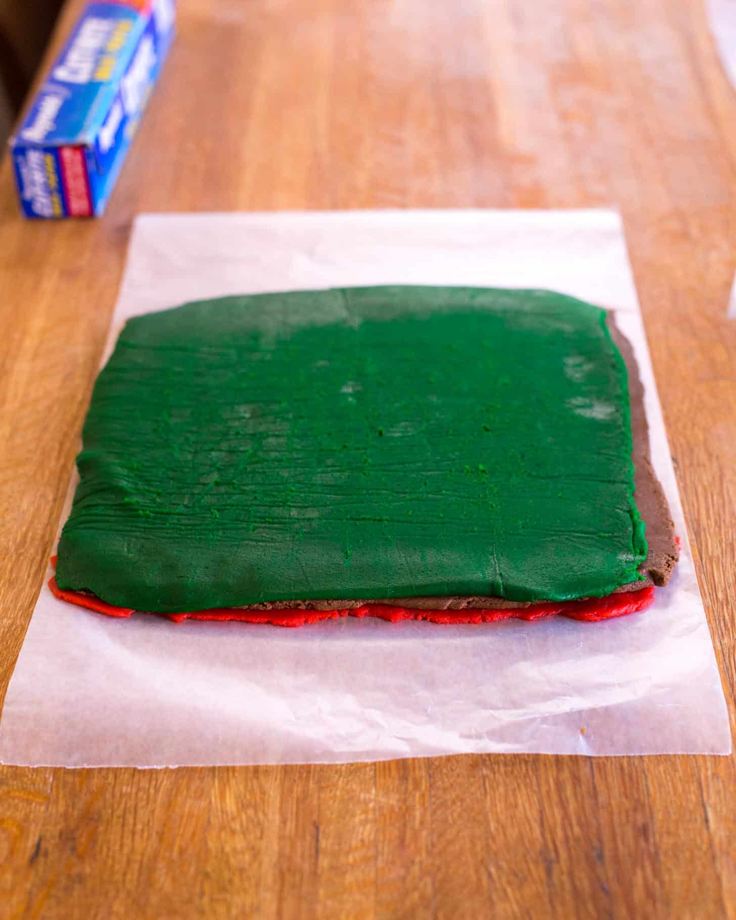 layers of colored dough on a parchment square