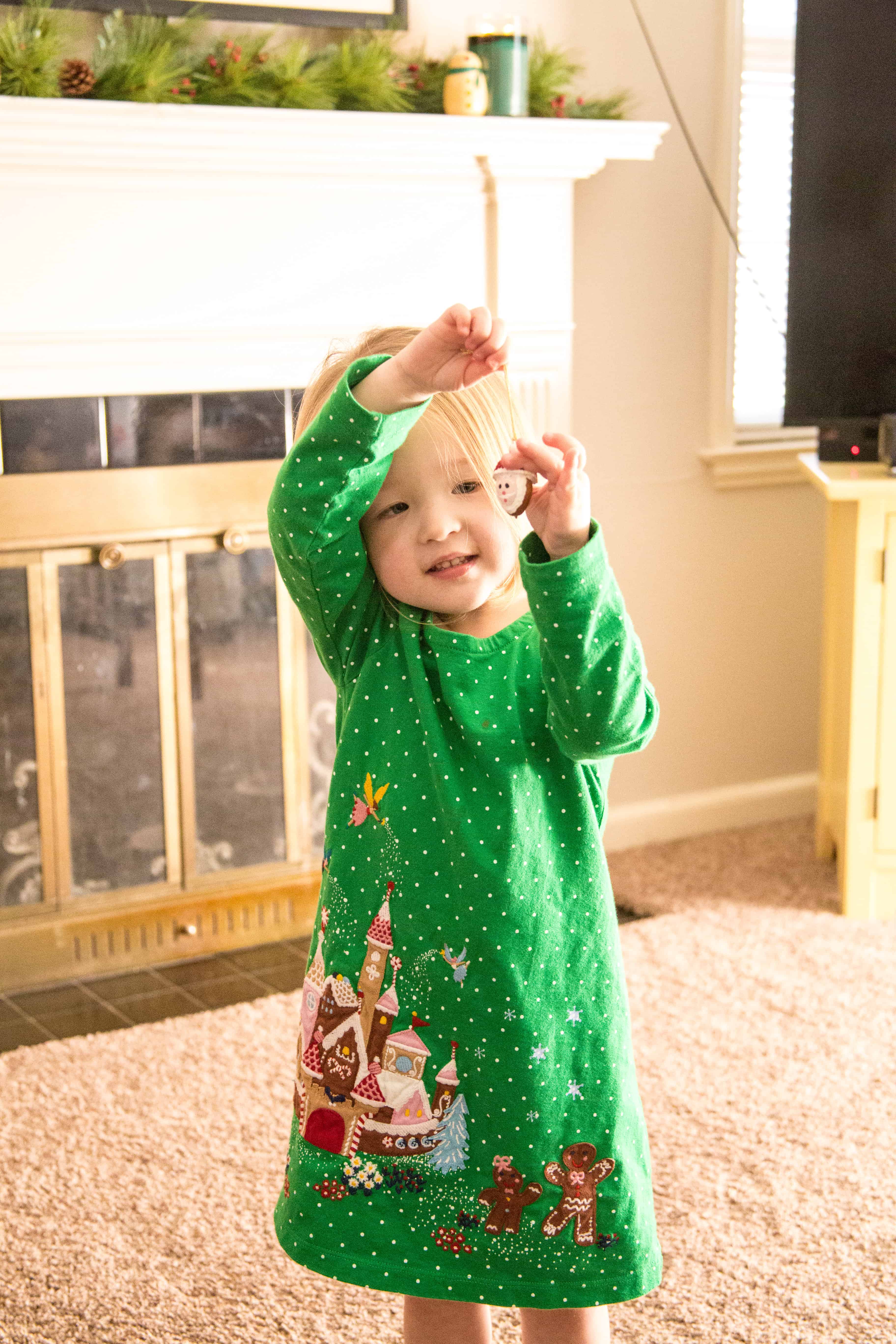 Clara holding a Christmas ornament