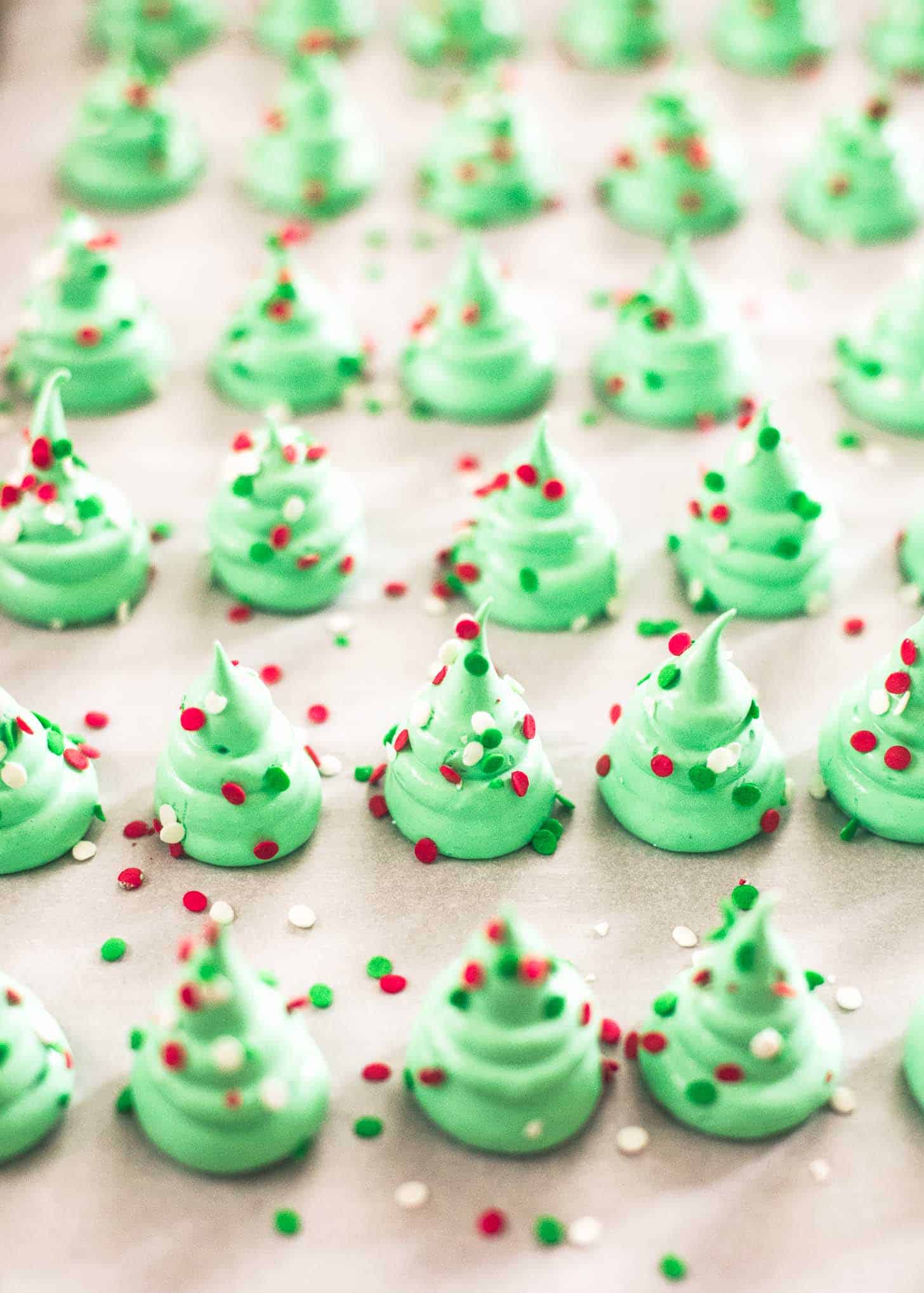 Christmas Tree Meringues on a parchment lined sheet pan