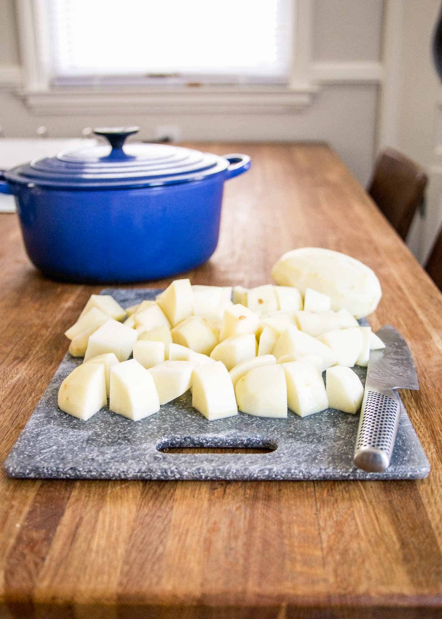 cutting potatoes on a cutting board