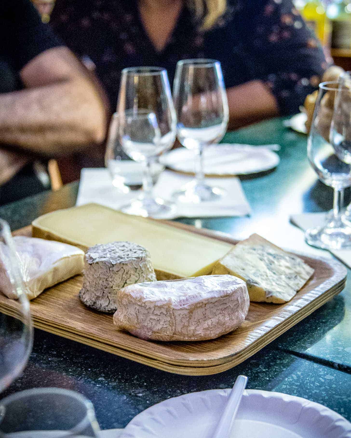 cheeses on a wooden board