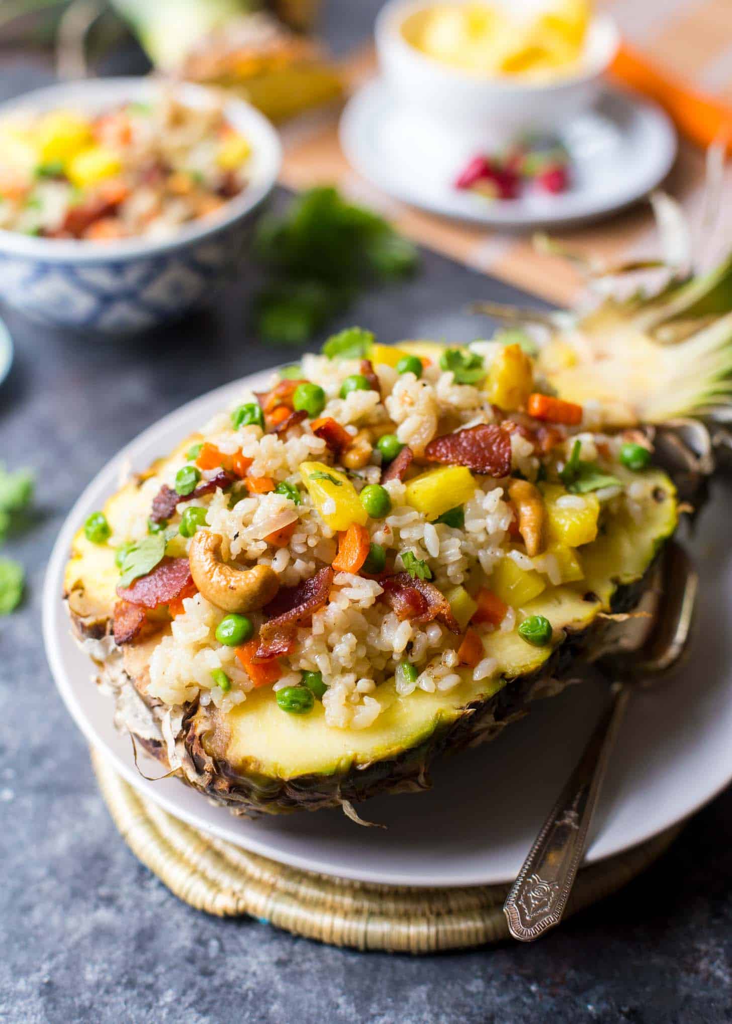 Fried Rice served in a half pineapple on a white plate